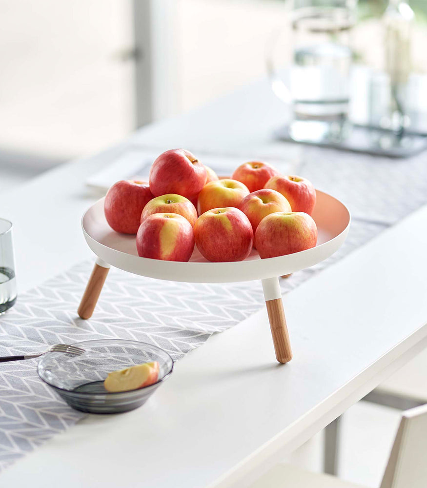 View 6 - White Yamazaki Countertop Pedestal Tray with apples on top on a dining table