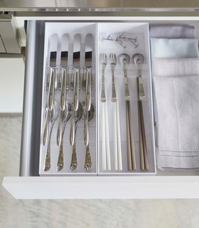 Aerial view of two white Cutlery Storage Organizers holding utensils in kitchen drawer by Yamazaki Home. view 6