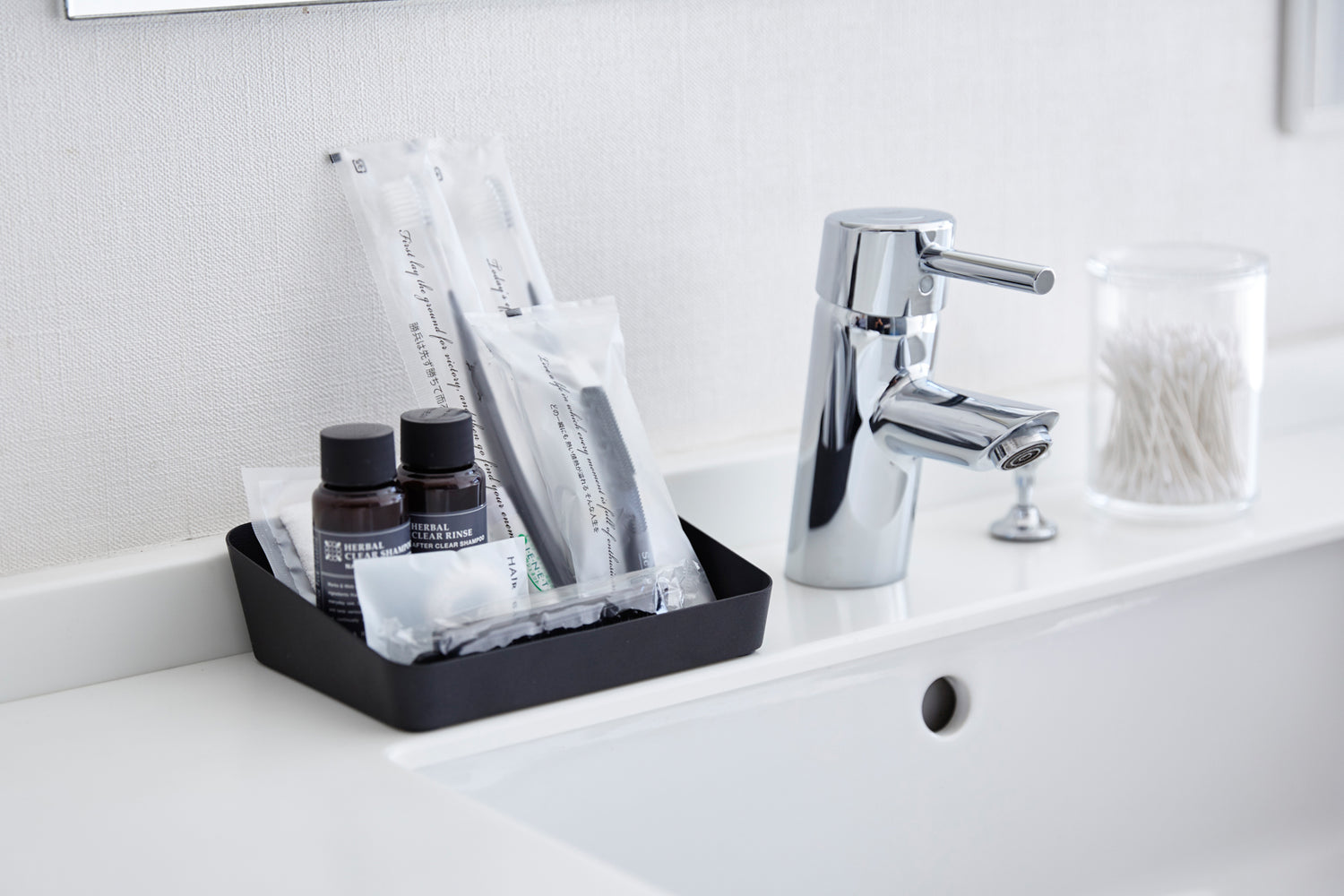 View 9 - Medium black Accessory Tray holding beauty products on bathroom sink counter by Yamazaki Home.