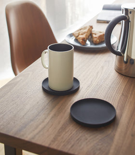 Yamazaki Home black Round Coaster on a dining table.
 view 6