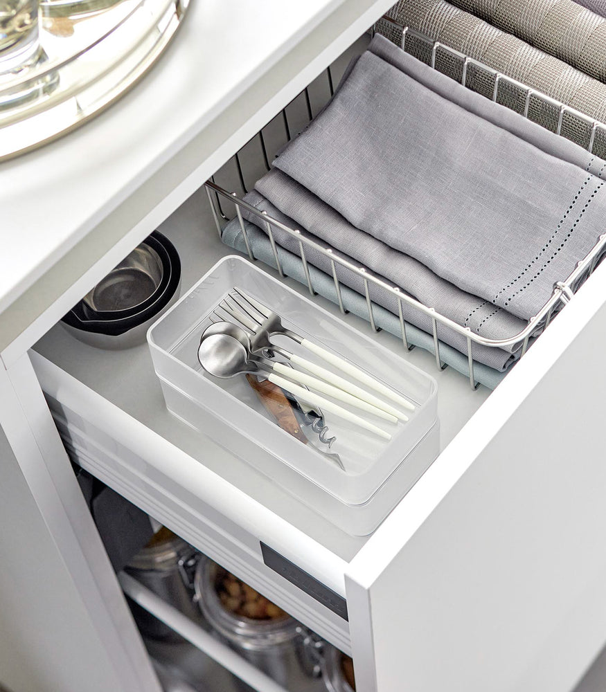 View 15 - Two medium stackable clear organizers are placed in a kitchen drawer, organizing cutlery and wine openers, neatly stacked together.