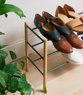 Close up side view of Forest Green Yamazaki Home Expandable Shoe Rack with 5 pairs of shoes view 7