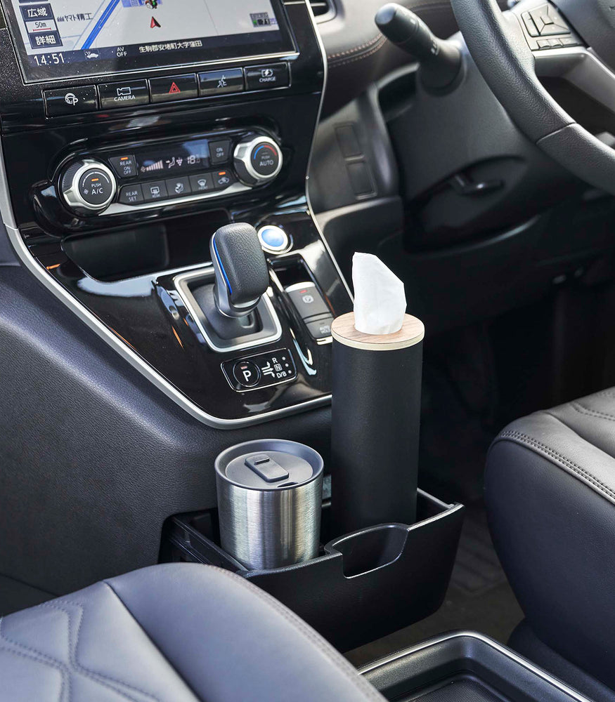 View 12 - Small black Yamazaki Home Round Tissue Case in the center console cup holder of a car