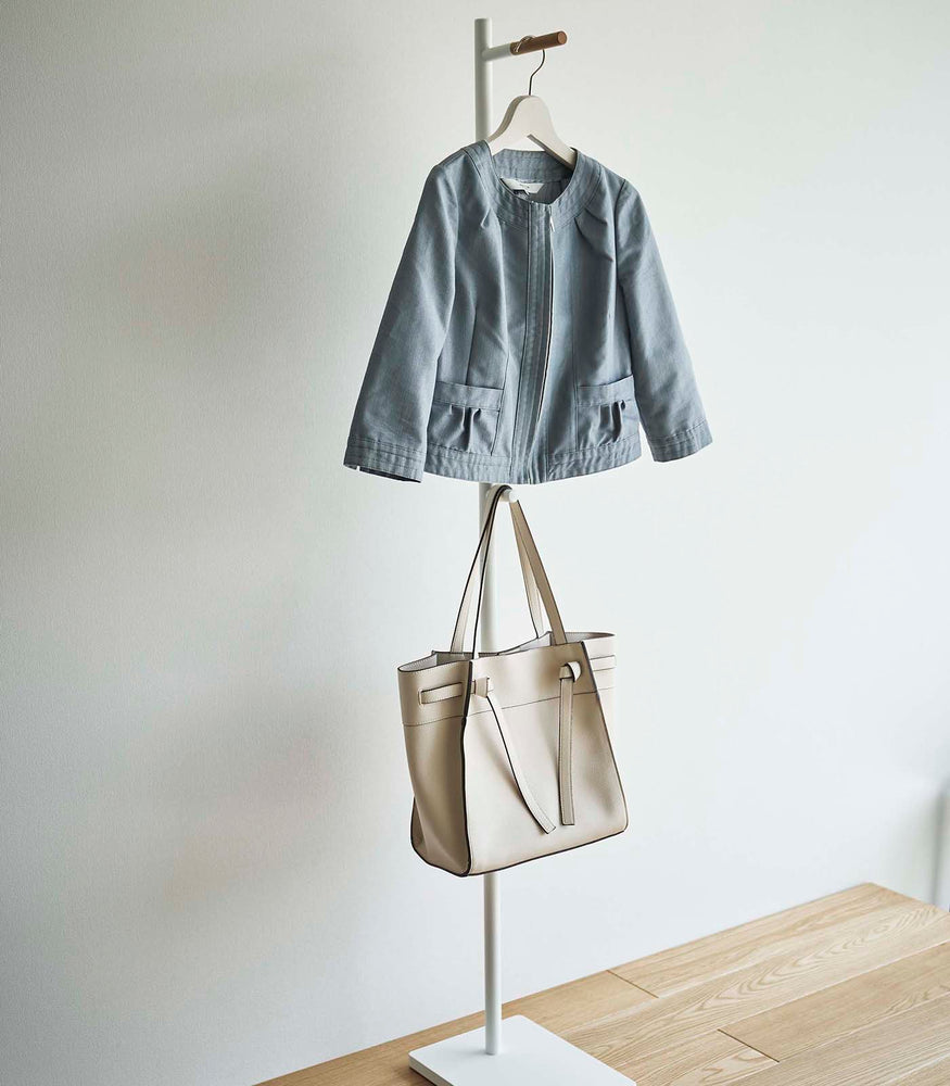 View 8 - White Yamazaki Coat Rack with a jacket and purse hanging on it in an entryway