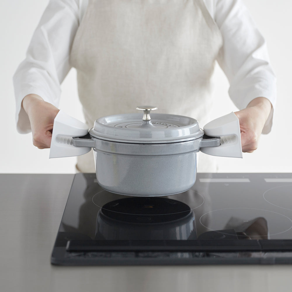 White Yamazaki Home Magnetic Pot Holders holding a dutch oven over a stove