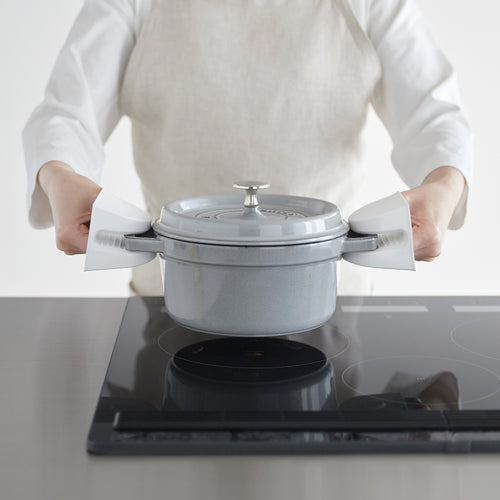 White Yamazaki Home Magnetic Pot Holders holding a dutch oven over a stove