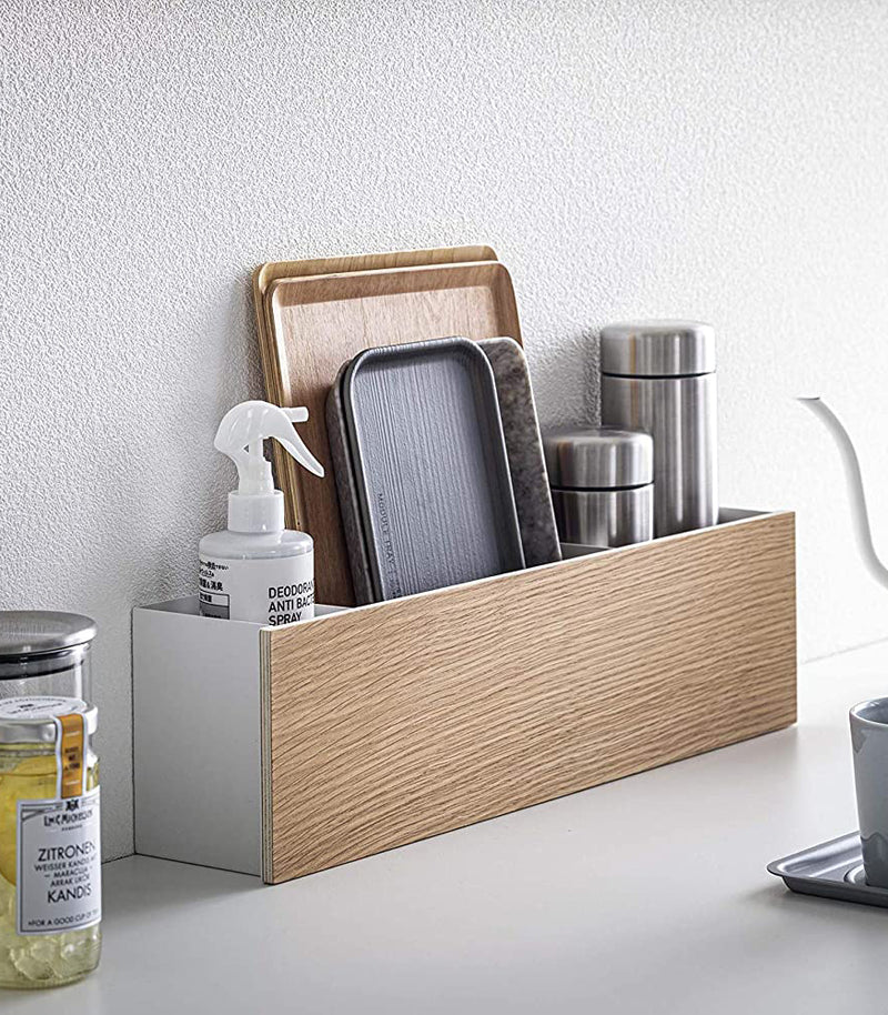Desk Organizer holding cleaning items, trays, and containers by Yamazaki Home.