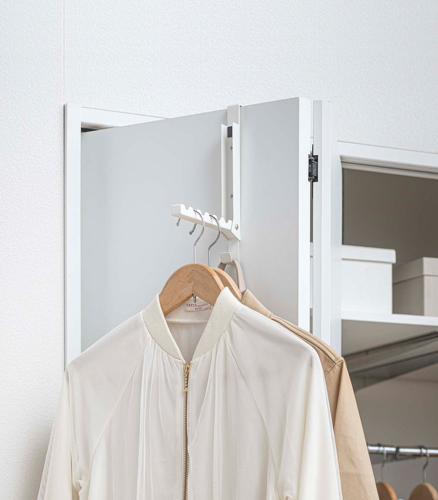 View 12 - White Yamazaki Home Folding Over-The-Door Hanger with jackets hung