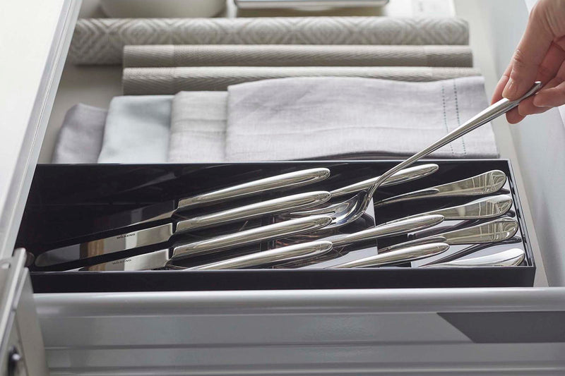 Close up side view of black Cutlery Storage Organizer holding silverware by Yamazaki Home.