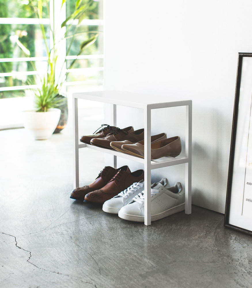 View 6 - Side view of white Shoe Organizer holding shoes by Yamazaki Home.
