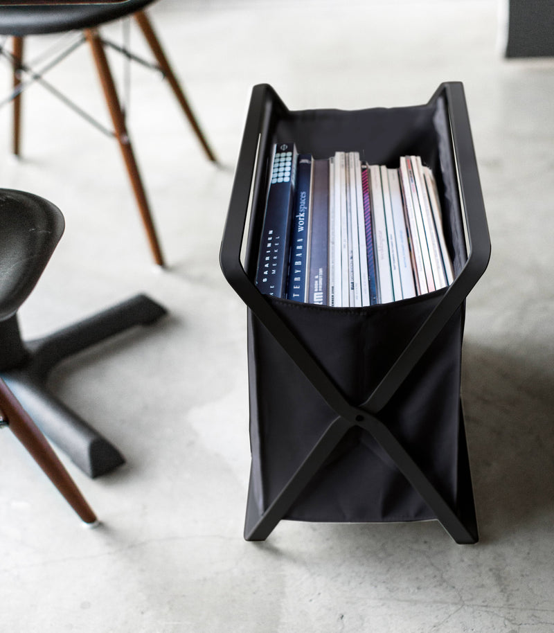 Side view of black Storage Hamper holding books by Yamazaki Home.