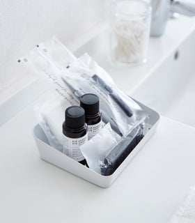 Aerial view of white Accessory Tray holding beauty products on bathroom sink counter by Yamazaki Home. view 3