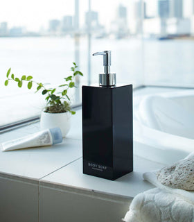 Black Yamazaki Home square body soap dispenser by bathtub view 18