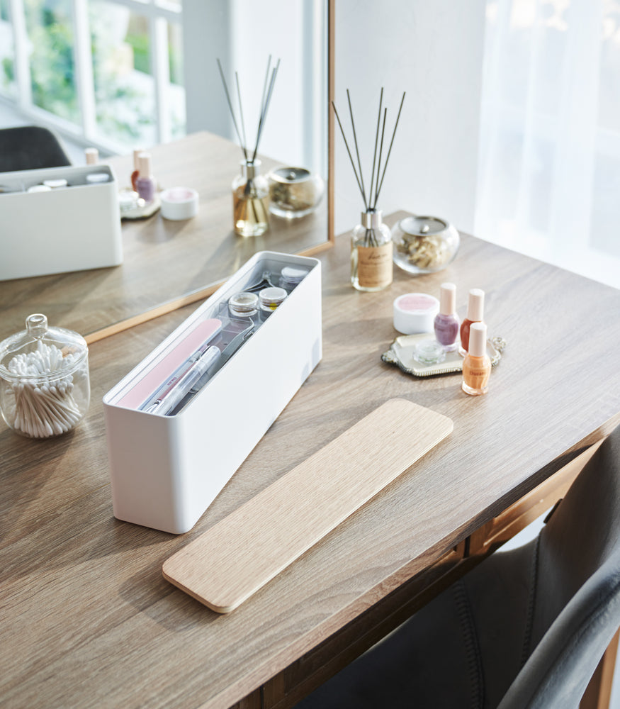 View 2 - An open Yamazaki Nail Polish Organizer holding various nail accessories on a table.