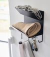 Magnetic Entryway Rack by Yamazaki Home in black mounted on a door storing various entryway items.