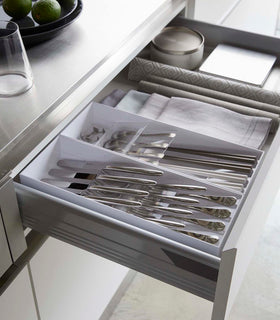 Two white Cutlery Storage Organizers holding utensils in kitchen drawer by Yamazaki Home. view 4