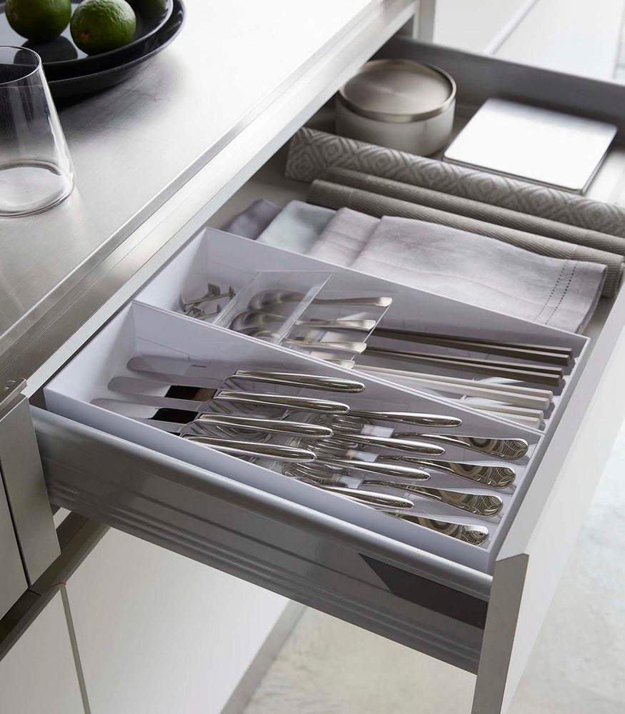 View 4 - Two white Cutlery Storage Organizers holding utensils in kitchen drawer by Yamazaki Home.