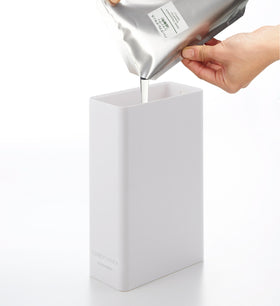 White Conditioner Dispenser filled with conditioner on white background by Yamazaki Home. view 14