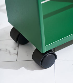 Close up of wheels on Forest Green Yamazaki Home Slim Storage Cart view 7