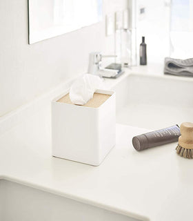 White Tissue Case holding tissues on bathroom sink counter by Yamazaki Home. view 3