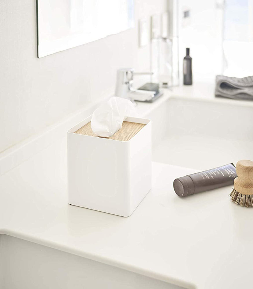 View 4 - White Tissue Case holding tissues on bathroom sink counter by Yamazaki Home.