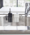 Front view of black Hand Soap Dispenser in kitchen sink by Yamazaki Home.