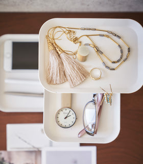 Top-down view of Yamazaki Home White Rin Series 3-Tiered Accessory Tray with accessories displayed such as a pen or a watch view 6