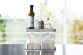 Front view of white Pantry Organizer holding sugar and flour with upper shelf holding spices and oil by Yamazaki Home. view 4