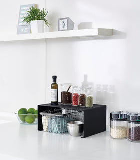 Back Stackable Countertop Shelf holding spices and oil in kitchen by Yamazaki Home. view 24
