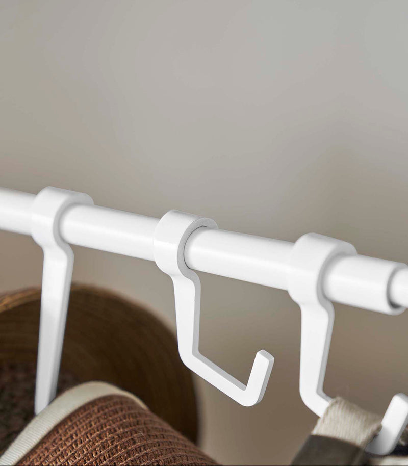 Close up of the hooks on white Yamazaki Home hat rack