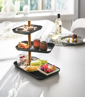 Yamazaki Home Black Rin Series 3-Tiered Accessory Tray with various desserts displayed view 14