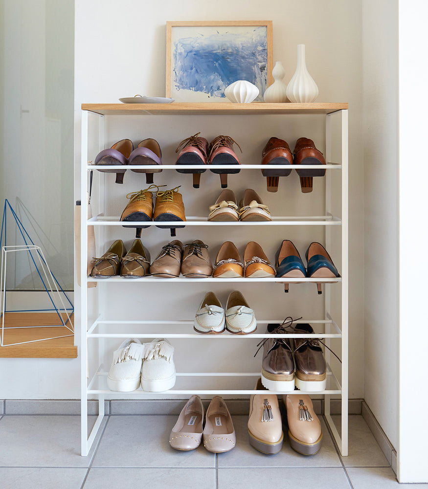 View 7 - Front view of white Shoe Rack in mudroom holding shoes by Yamazaki Home.