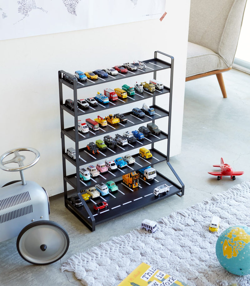 Black Kids' Parking Garage displaying toy cars in playroom by Yamazaki Home.