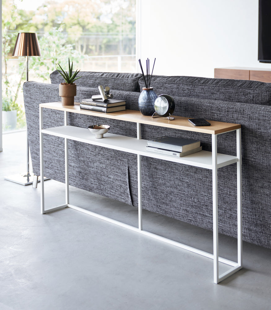 View 18 - White Yamazaki Home Long Console Table - Shelf  with books and decorations on it