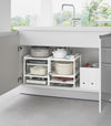 Two of Yamazaki Home Three-Tier Cabinet Storage Rack holding pot and pans and kitchen essentials.