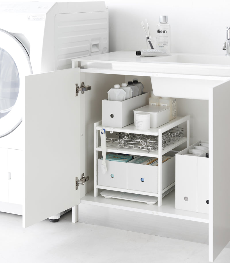 Yamazaki Home white Three-Tier Cabinet Storage Rack holding bathroom essentials.