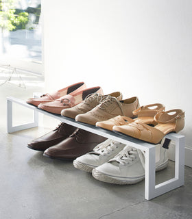 Entryway white Expandable Shoe Rack holding shoes by Yamazaki home. view 3