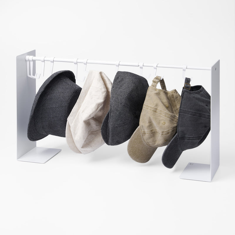 Yamazaki Home Hat Hanging Organizer with props, set against a white background.