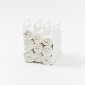 Yamazaki Home Towel Storage Organizer with props, set against a white background.