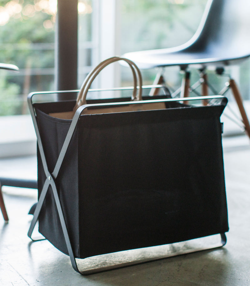 Front view of black Storage Hamper holding bag by Yamazaki Home.