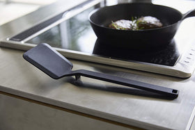 Side view of black Floating Spatula on kitchen counter by Yamazaki Home. view 9