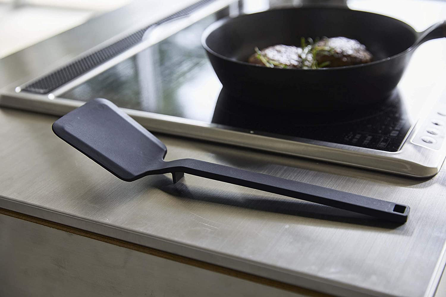 View 9 - Side view of black Floating Spatula on kitchen counter by Yamazaki Home.