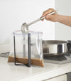 Small black Yamazaki Collapsible Bottle Dryer in a kitchen holding a bag to ladle gravy