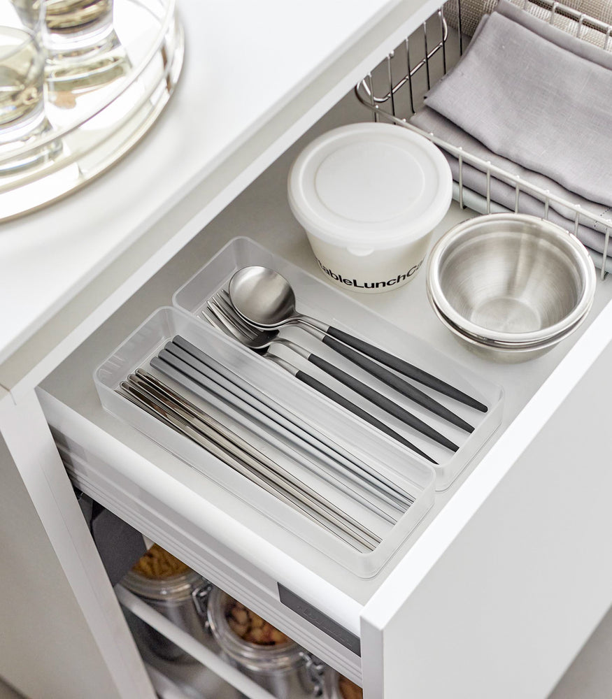 View 33 - Two large stackable clear organizers are placed in a kitchen drawer, organizing cutlery, neatly placed next to each other