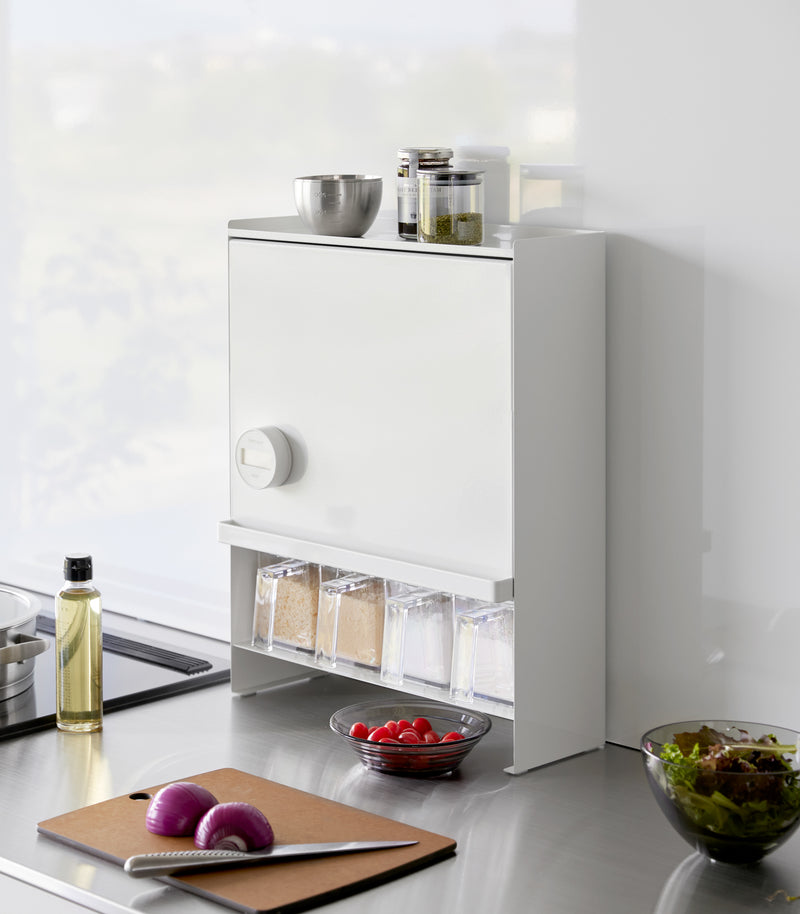 Diagonal view of the Concealable Spice Rack in white by Yamazaki Home with the front panel closed.