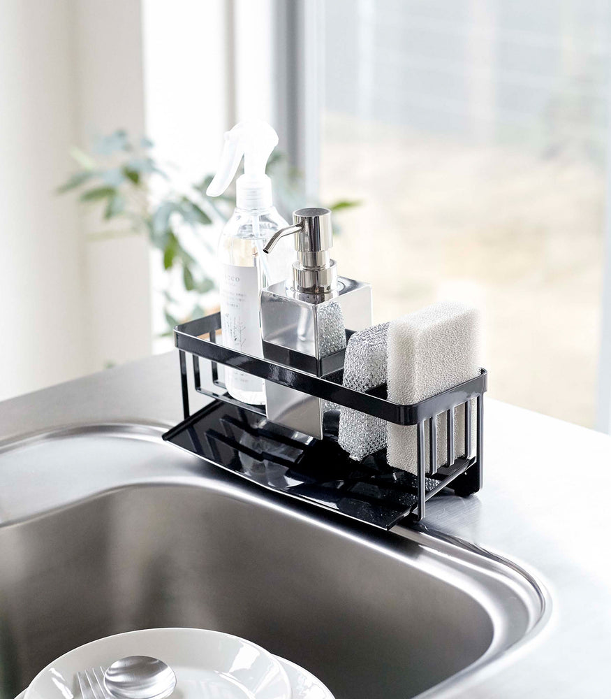 View 13 - Black steel sponge and soap bottle holder with black draining tray.
