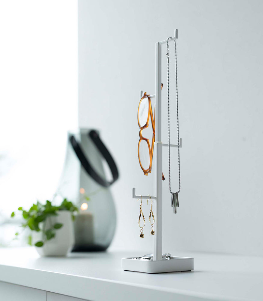 View 6 - White Yamazaki Home Tree Accessory Stand with glasses and other accessories displayed