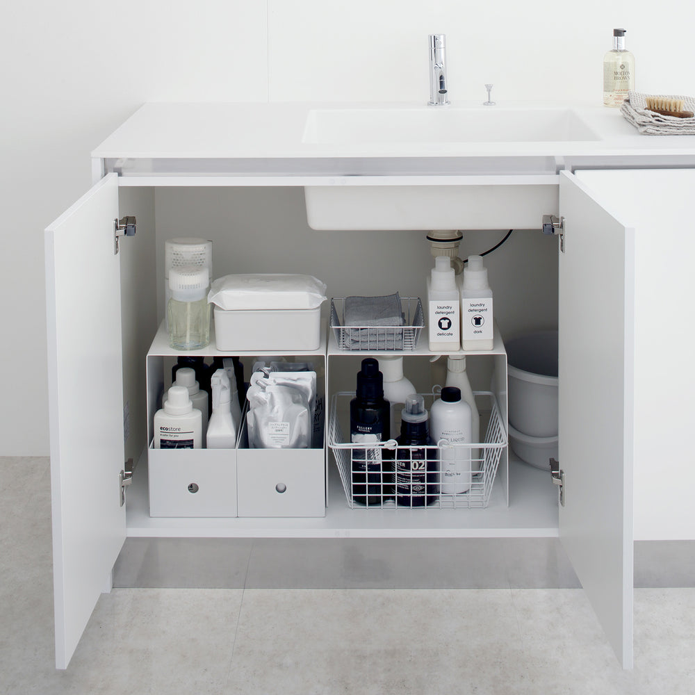 View 4 - Yamazaki White Under-Cabinet Storage Shelves holding bathroom essentials.