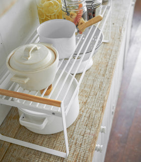 Bird's eye view of white wired organizer rack holding cups, jars, and bowls. view 5