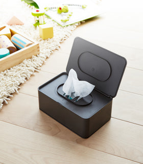 Aerial view of open black Wet Tissue Case containing wet wipes by Yamazaki Home. view 11